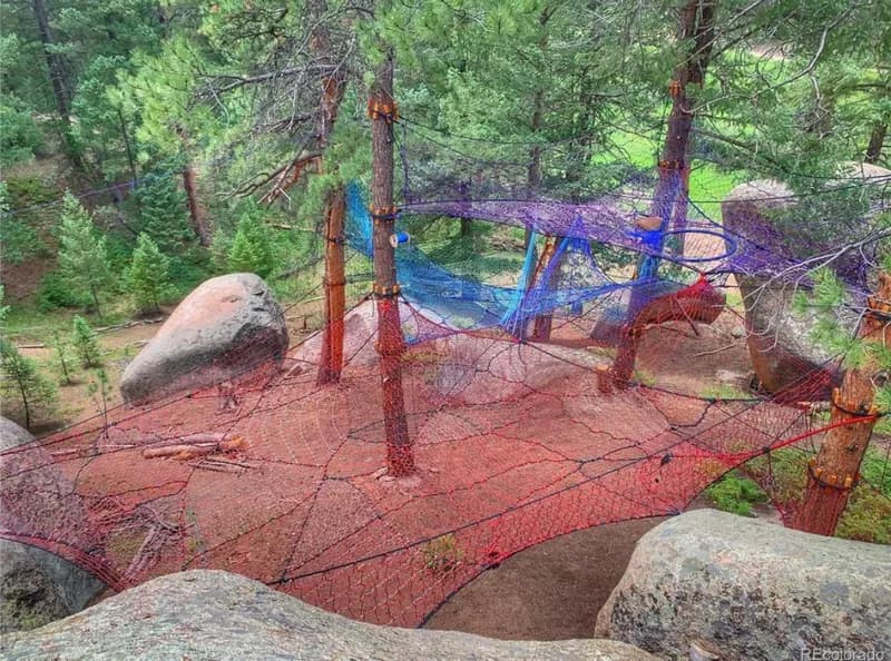 Colorful aerial tree nets suspended among Colorado pines